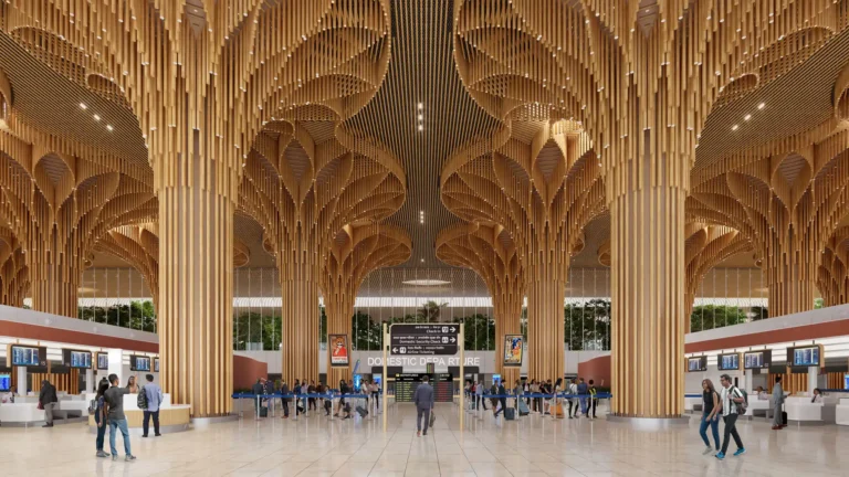 Departure hall of Guwahati International Airport Terminal 2 featuring bamboo-inspired columns and sculptural wooden ceiling design.