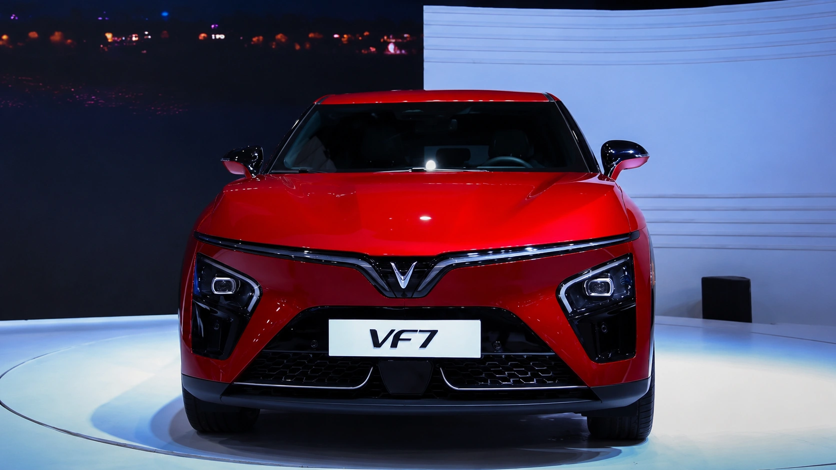 Front view of red VinFast VF7 electric SUV showcased in a modern display setting, representing Green SM and India's evolving EV mobility ecosystem