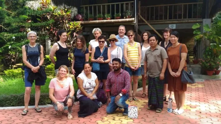 International visitors with their hosts outside a traditional homestay in Northeast India.